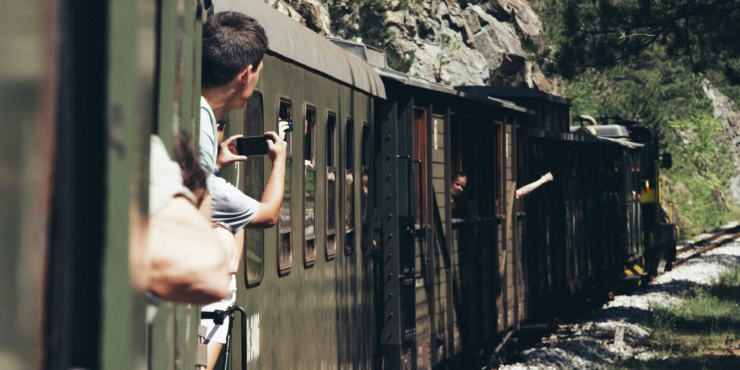 Pendant un trajet en train, plusieurs personnes se disent bonjour à travers les fenêtres des différents wagons